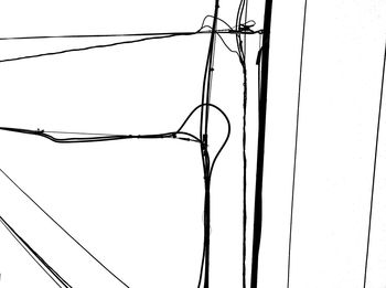Low angle view of electricity pylon against clear sky