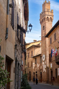 Low angle view of building along a street of buonconvento, tuscany, italy