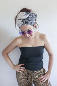 Portrait of a young woman wearing sunglasses and a bandana