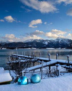 Scenic view of snow and mountains against blue sky