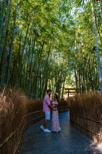 Couple embracing while standing amidst trees