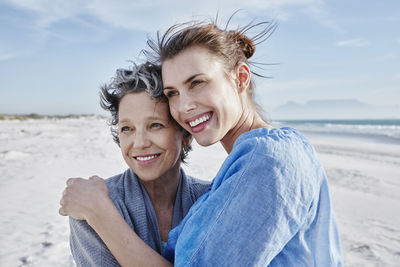 Portrait of mother and her adult daughter on the beach