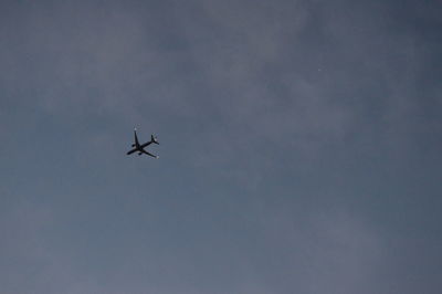 Low angle view of airplane flying in sky