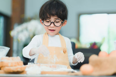 Portrait of boy with ice cream on table