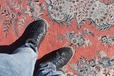 Low section of man standing on carpet