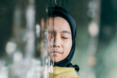 Girl in hijab by water