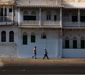 People walking on building in city