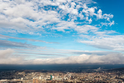 Aerial view of town against sky