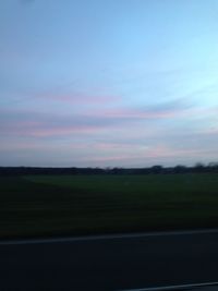 Country road against cloudy sky