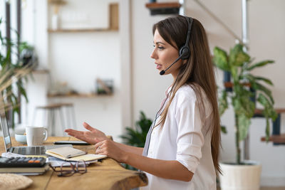 Side view of businesswoman working in office