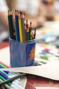 Close-up of colorful pencils in container on table