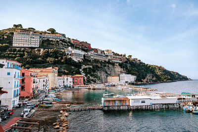 High angle view of townscape by sea against sky