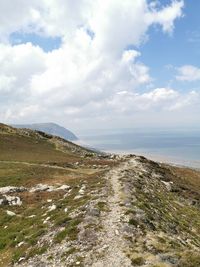 Scenic view of land and sea against sky