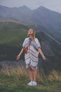 Full length of woman standing on mountain