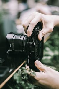 Midsection of person photographing camera