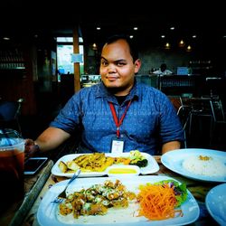 Portrait of man sitting in restaurant