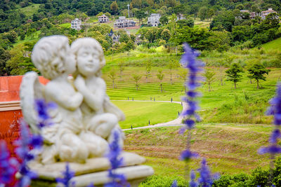 View of statue by plants in park