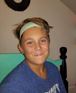 Portrait of boy smiling against wall at home