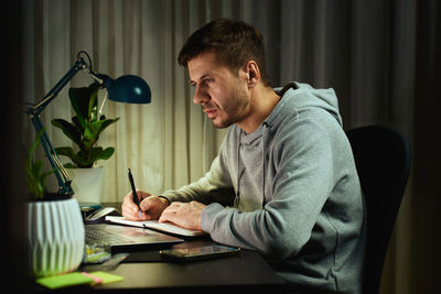 Young man using laptop at home