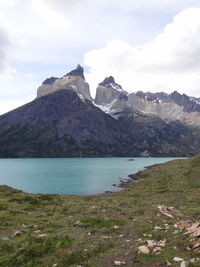 Scenic view of mountains against cloudy sky