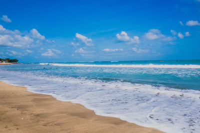 Scenic view of beach against blue sky