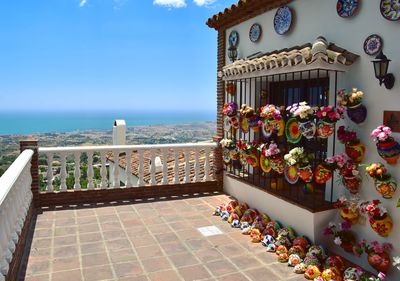 Entrance of building by sea against sky