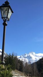 Low angle view of mountain against blue sky