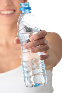 Close-up of hand holding glass bottle