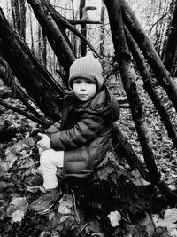 Child sitting in fall woods