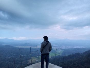 Rear view of man standing on mountain