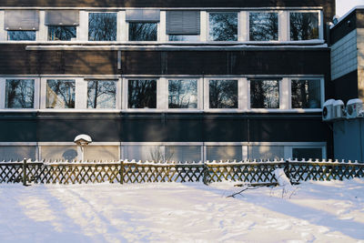 View of snow covered railing against building