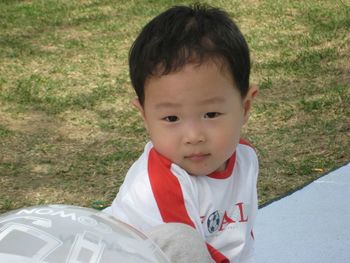 Portrait of cute boy on field