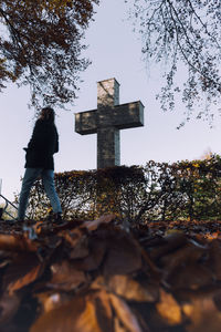 Low angle view of cross on tree against sky