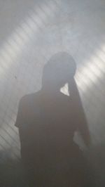 High angle view of silhouette woman shadow on floor