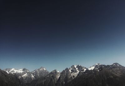 Scenic view of mountains against clear blue sky