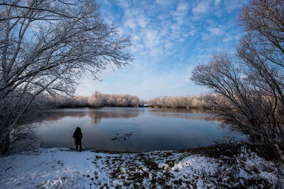 Scenic view of lake against sky during winter