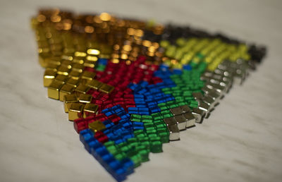 Cubes of different colors. chips from board game. triangle shape made of small glasses. 