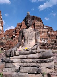 Sculpture of buddha statue against sky