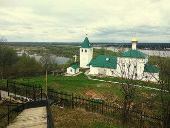 High angle view of church against cloudy sky