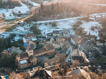 High angle view of river amidst buildings during winter