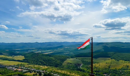 Flag on landscape against sky