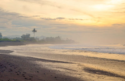 Scenic view of beach against sky during sunset