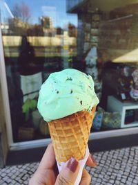 Cropped hand holding ice cream