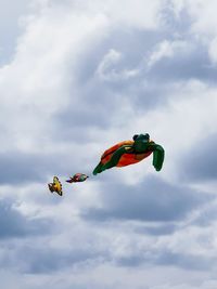 Low angle view of balloons flying against sky