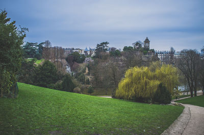 Scenic view of grassy field against sky