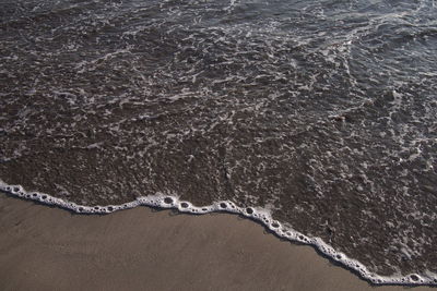 High angle view of surf on beach