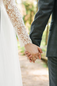 Wedding couple, lovers bride and groom holding hands go