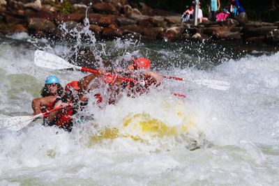 People kayaking in river