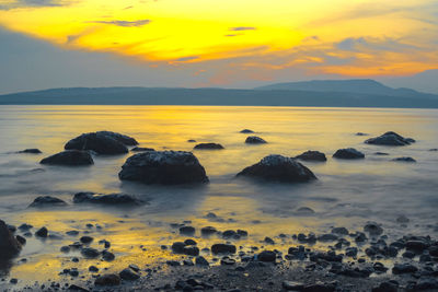 Rocks on the beach during sunrise in banyuwangi, indonesia.