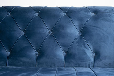 Close-up of sofa against blue sky